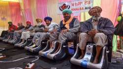 Farmers take foot massage, set up by an international NGO, at Singhu border during their sit-in protest against the Centres farm reform laws, in New Delhi.