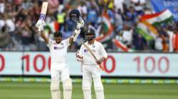 India's Ajinkya Rahane, left, celebrates after scoring a century as teammate Ravindra Jadeja watches during play on day two of the second cricket test between India and Australia at the Melbourne Cricket Ground, Melbourne, Australia, Sunday, Dec. 27