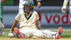 Australia's Joe Burns sits on the pitch as he awaits a video review during play on day three of the second cricket test between India and Australia at the Melbourne Cricket Ground, Melbourne, Australia, Monday, Dec. 28