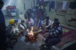 New Delhi: Farmers sit near a bonfire during their sit-in protest against the Centres farm reform laws, near Ghazipur border in New Delhi, Saturday, Dec. 12, 2020.