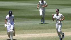 Australia's Pat Cummins, right, celebrates after taking the wicket of India's Cheteshwar Pujara, left, during play on day four of the second cricket test between India and Australia at the Melbourne Cricket Ground, Melbourne, Australia, Tuesday, Dec. 29