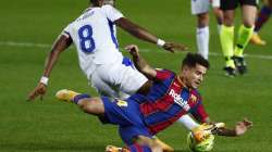 Eibar's Pape Diop, left, challenges Barcelona's Philippe Coutinho during the Spanish La Liga soccer match between Barcelona and Eibar at the Camp Nou stadium in Barcelona in Barcelona, Spain, Tuesday, Dec. 29