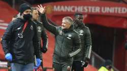 Manchester United's manager Ole Gunnar Solskjaer waves towards the directors box as he walks to the technical area ahead of the English Premier League soccer match between Manchester United and Aston Villa at Old Trafford in Manchester, England, Friday, Jan. 1