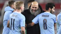 Manchester City's head coach Pep Guardiola, right, congratulates his players after the English League Cup semifinal soccer match between Manchester United and Manchester City at Old Trafford in Manchester, England, Wednesday, Jan. 6,