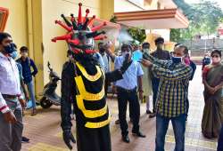 A volunteer wears a dress themed on coronavirus during a demonstration to create awareness at a school that was reopened after the authorities allowed to conduct classes for SSLC and 12th Standard students in Bengaluru.