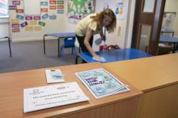 Reception teacher Elizabeth Dockry cleans her classroom as measures are taken to prevent the transmi