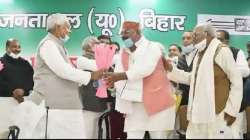 Bihar Chief Minister Nitish Kumar and JD(U) National President RCP Singh (R) greet newly elected party state President Umesh Kushwaha (C) during the second day of party state council meeting, in Patna.