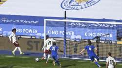 Arsenal's Nicolas Pepe, second left, scores his side's third goal during the English Premier League soccer match between Leicester City and Arsenal at the King Power Stadium in Leicester, England, Sunday, Feb. 28