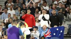 Fans cheer for Australia's Nick Kyrgios, back to camera, during his third round match against Austria's Dominic Thiem at the Australian Open tennis championship in Melbourne, Australia, Friday, Feb. 12