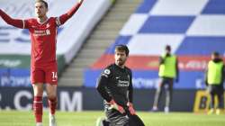 Liverpool's Jordan Henderson, left, and Liverpool's goalkeeper Alisson react to the linesman after Leicester's James Maddison scores his side's opening goal during the English Premier League soccer match between Leicester City and Liverpool at the King Power Stadium in Leicester, England, Saturday, Feb. 13