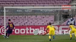 Barcelona's Lionel Messi scores from a penalty kick, during the Spanish La Liga soccer match between FC Barcelona and Cadiz at the Camp Nou stadium in Barcelona, Spain, Sunday, Feb. 21