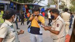 BMC officials penalise a commuter for not wearing masks, amid rise in coronavirus cases across Maharashtra, in Mumbai.