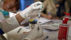 A health worker prepares to administer COVISHIELD vaccine to an elderly man at a government hospital in Noida, a suburb of New Delhi.