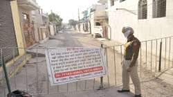 A police constable stands guard outside a containment zone after some residents tested positive with COVID-19, in Patiala.