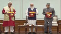 Prime Minister Narendra Modi releases 11 volumes of manuscript with commentaries by 21 scholars on shlokas of Srimad Bhagavadgita, in New Delhi. Jammu and Kashmir Lt Gov Manoj Sinha (Left) and senior Congress leader Karan Singh (Right) are also seen.