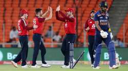 Mark Wood of England celebrates the wicket of KL Rahul of India with (L-R) Eoin Morgan and Jason Roy during the 3rd T20 International between India and England at Narendra Modi Stadium on March 16