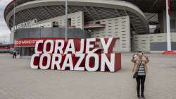 A woman takes a snapshot in front Atletico Madrid's Wanda Metropolitano stadium in Madrid, Spain, Tuesday, April 20