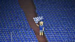 In this Feb.20, 2021 file photo Schalke mascot Erwin waves a team flag from the stands during the German Bundesliga soccer match between FC Schalke 04 and Borussia Dortmund in Gelsenkirchen