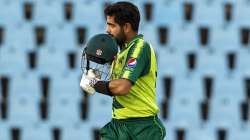 Pakistan's captain Babar Azam raises his helmet to celebrate scoring a century during the fourth T20 cricket match between South Africa and Pakistan at Centurion Park in Pretoria, South Africa, Wednesday, April 14