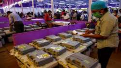 Polling officers check electronic voting machines at a distribution centre.