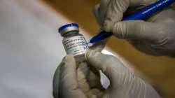 A health worker writes the date and time on a vial of the COVAXIN vaccine before administering the jab.