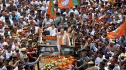 BJP candidate from Jalukbari constituency Himanta Biswa Sarma waves at his supporters during a rally before filing his nomination papers, ahead of the Assam Assembly Polls, in Guwahati.