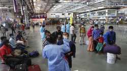 A health worker collects swab sample of travelers to test for COVID-19 at the Chhatrapati Shivaji Maharaj train Terminus in Mumbai.