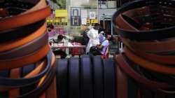 A health worker takes a swab sample to test for COVID-19 outside shopping mall in Mumbai.