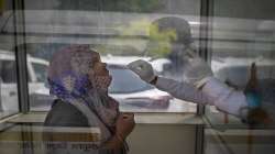 A health worker takes a swab sample to test for COVID-19 at a government hospital.