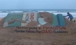 Puri: Artist Sudarshan Pattnaik gives finishing touches to a sand sculpture to create awareness of 'Tika Utsav', a vaccine festival called by Prime Minister Narendra Modi, in Puri, Saturday, April 10, 2021.