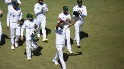 Pakistan bowler Hassan Ali ,centre, holds a cricket ball after taking 5 wickets, during the second test cricket match between Zimbabwe and Pakistan at Harare Sports Club, Sunday, May, 9, 2021