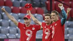 Bayern's Robert Lewandowski, left, Bayern's Thomas Mueller, centre, and Bayern's goalkeeper Manuel Neuer celebrate at the end of the German Bundesliga soccer match between Bayern Munich and Borussia Moenchengladbach at the Allianz Arena stadium in Munich, Germany, Saturday, May 8