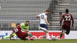 Tottenham's Harry Kane, center, scores the opening goal during the English Premier League soccer match between Tottenham Hotspur and Wolverhampton Wanderers at Tottenham Hotspur Stadium in London, England, Sunday, May 16