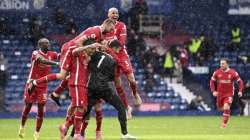 Liverpool's goalkeeper Alisson celebrates with teammates after scoring his side's second goal during the English Premier League soccer match between West Bromwich Albion and Liverpool at the Hawthorns stadium in West Bromwich, England, Sunday, May 16