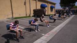 Children ages 12 to 15 wait to get their vitals checked before getting their Pfizer COVID-19 vaccine at Families Together of Orange County in Tustin, Calif.