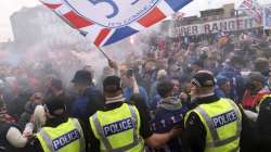 Police and Rangers fans face off outside the soccer ground before the Scottish Premiership soccer match against Aberdeen at Ibrox Stadium in Glasgow, Saturday May 15, 2021. Rangers on Saturday will lift their first Scottish Premiership trophy in a decade