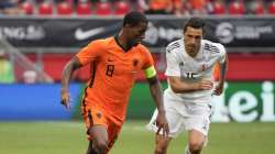 Netherlands' Georginio Wijnaldum, left, and Georgia's Giorgi Aburjania vie for the ball during the friendly soccer match between The Netherlands and Georgia, in the run-up to the Euro2020 soccer tournament, in Enschede, eastern Netherlands, Sunday, June 6