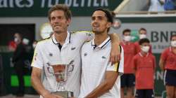 France's Nicolas Mahut, left, and Pierre-Hugues Herbert hold tier trophy after defeating Kazakstan's Alexander Bublik and Andrey Golubev in their men's doubles final match of the French Open tennis tournament at the Roland Garros stadium Saturday, June 12