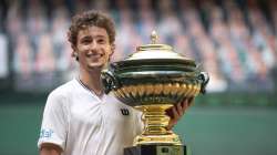 Ugo Humbert of France celebrates with the trophy after winning the final of the ATP tennis tournament in Halle, Germany, Sunday, June 20