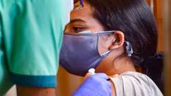 A health worker administers a dose of the Covid-19 vaccine to a benificiary, in Bengaluru.