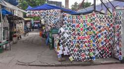 Facemasks for sale at a roadside stall as the street wears a deserted look amidst surge in coronavirus cases across the country.