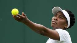 Venus Williams of the US serves to Romania's Mihaela Buzarnescu during the women's singles first round match on day two of the Wimbledon Tennis Championships in London, Tuesday June 29