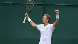 Sebastian Korda of the US celebrates defeating Australia's Alex De Minaur after the men's singles first round match on day two of the Wimbledon Tennis Championships in London, Tuesday June 29,