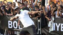 Jamaican sprinter Usain Bolt strikes his now-famous victory pose after defeating a mototaxi in a 50-meter race in Lima, Peru