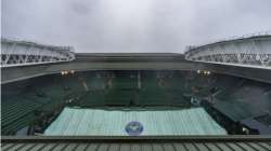 Covers remain in place on the Centre Court as rain continues to fall in the early morning ahead of the first day's play at Wimbledon Tennis Championships in London Monday June 28