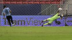 Colombia's goalkeeper David Ospina, right, stops a penalty shot by Uruguay's Matias Vina in a the penalty shootout during a Copa America quarterfinal soccer match at the National stadium in Brasilia, Brazil, Saturday, July 3