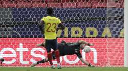 Argentina's goalkeeper Emiliano Martinez stops a penalty shot by Colombia's Davinson Sanchez in a the penalty shootout during a Copa America semifinal soccer match at the National stadium in Brasilia, Brazil, Wednesday, July 7