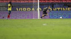 Argentina's goalkeeper Emiliano Martinez, right, reacts after stoping a penalty shot by Colombia's Davinson Sanchez, left, in a the penalty shootout during a Copa America semifinal soccer match at the National stadium in Brasilia, Brazil, Wednesday, July 7