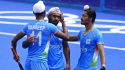 India's Mandeep Singh celebrates after India's Simranjeet Singh scores against Spain. 