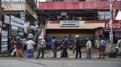 People wearing masks as a precaution against the coronavirus queue up maintaining physical in Kochi, Kerala.